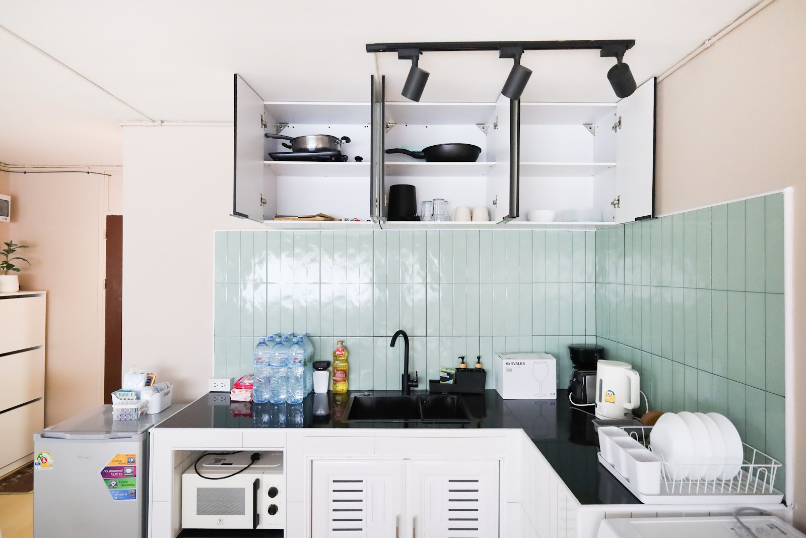 Mint-tiled kitchen with washer