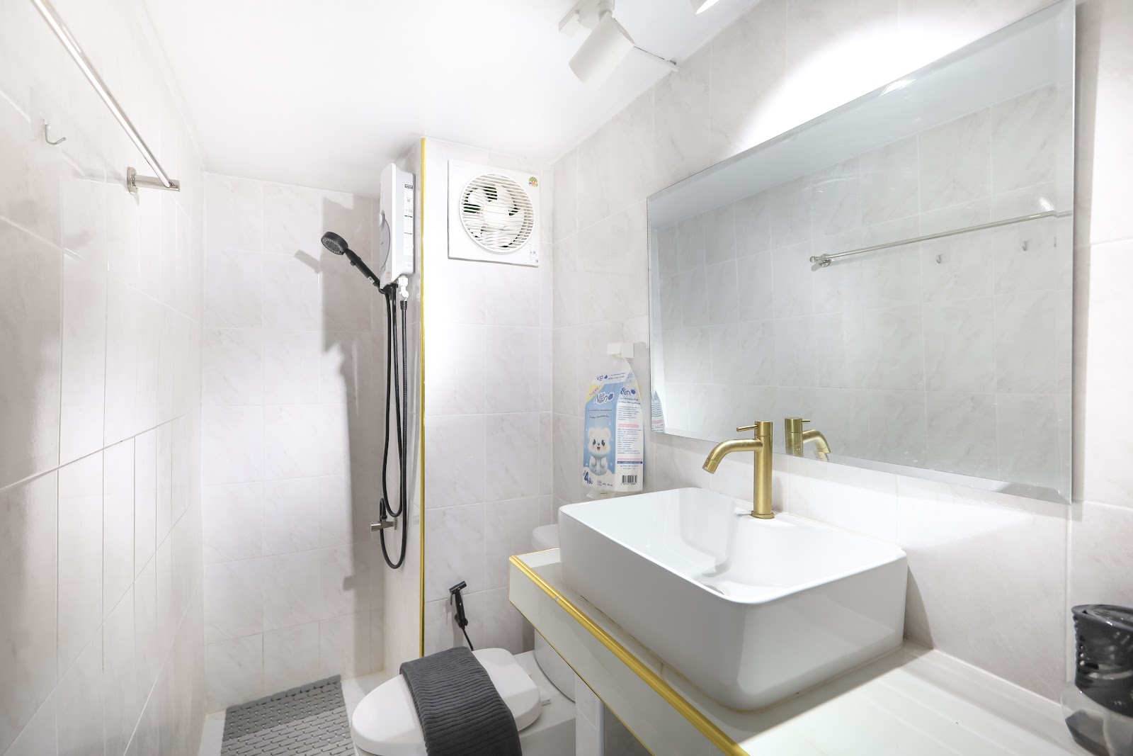Bathroom with gold fixtures and hot shower